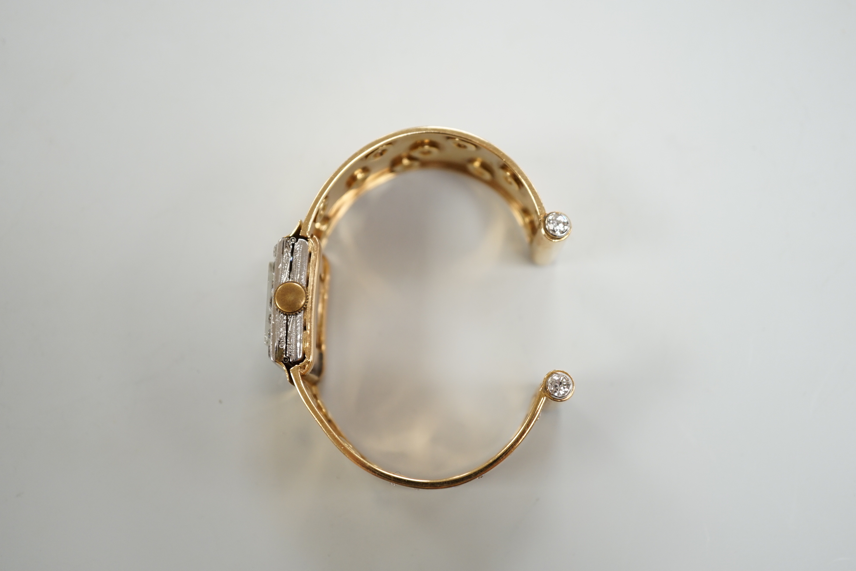 A yellow metal and diamond set Concorde manual wind open bracelet watch, with diamond set bezel and bracelet, gross weight 47.8 grams.